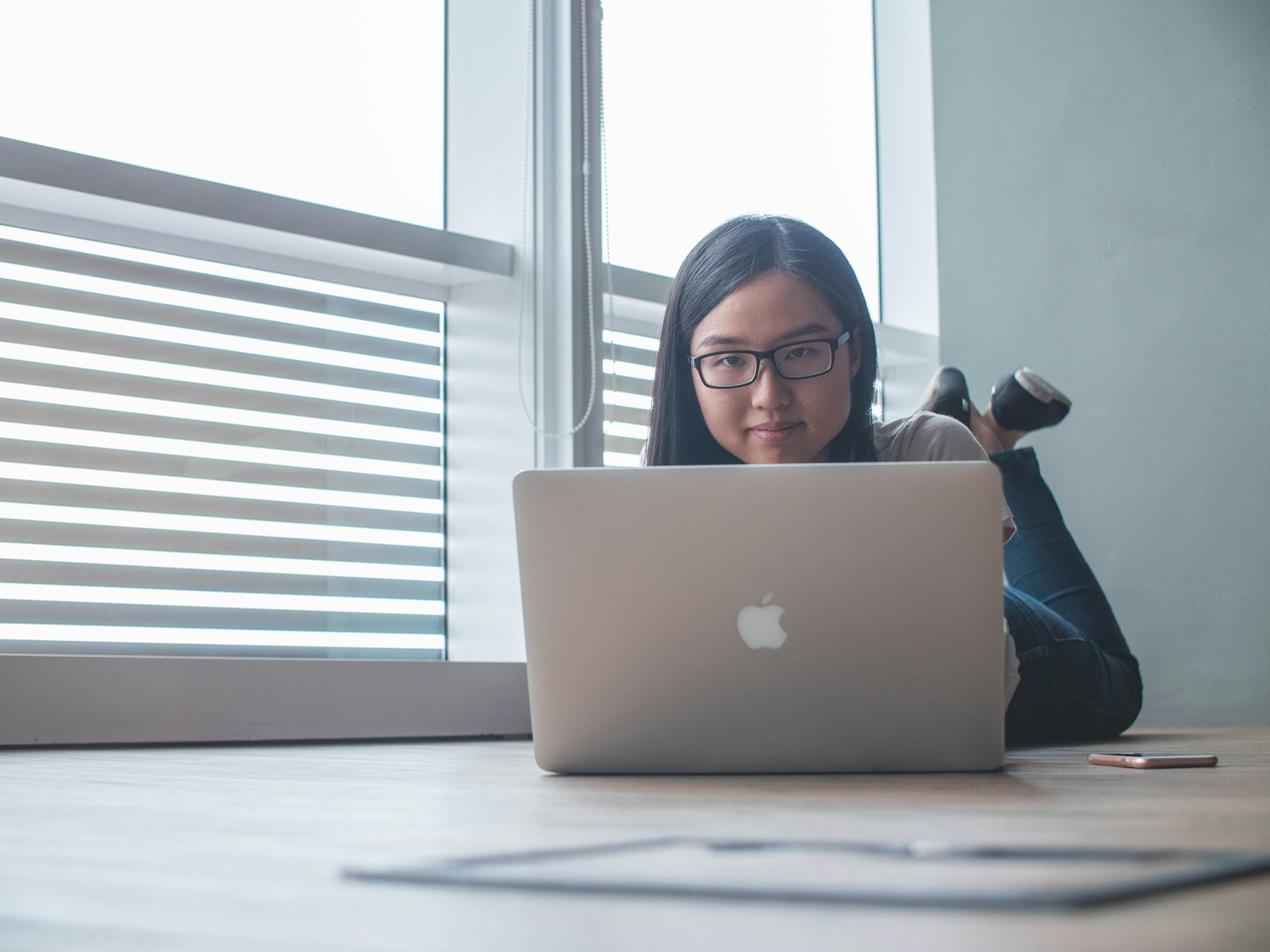 A professional making a decision while working on a laptop